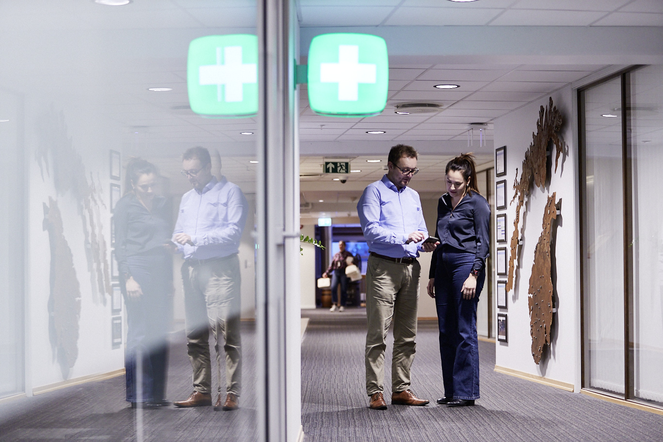 Healthcare Intelligence Two pharmacy workers standing in a hall in a hospital